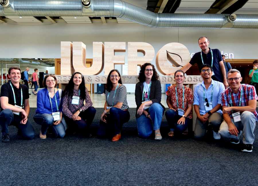Form group photo in front of giant IUFRO sign